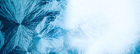 Winter background and Christmas art concept. Ice frost on frozen window glass with natural frosty pattern and texture design as holiday card backdropの写真素材