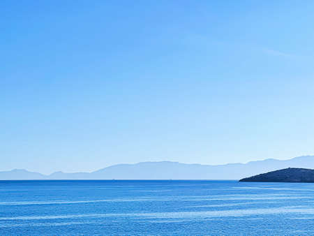 Seascape and coastal nature background. Blue sea and mountains in the morningの写真素材