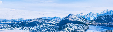 Winter wonderland and magical Christmas landscape. Snowy mountains and forest covered with snow as holiday backgroundの写真素材