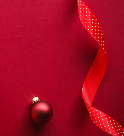 Christmas flatlay and holiday design concept. Decoration, ornament and xmas gift wrapping on red paper background as flat lay top viewの写真素材