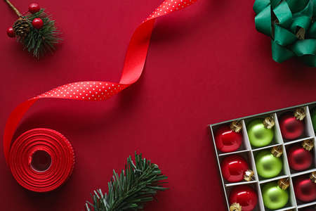 Christmas flatlay and holiday design concept. Decoration, ornament and xmas gift wrapping on red paper background as flat lay top viewの写真素材