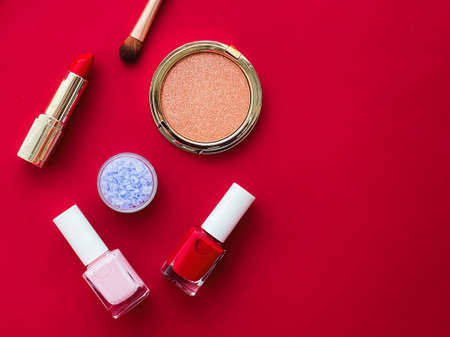 Beauty, make-up and cosmetics flatlay design with copyspace, cosmetic products and makeup tools on red background, girly and feminine style conceptの写真素材