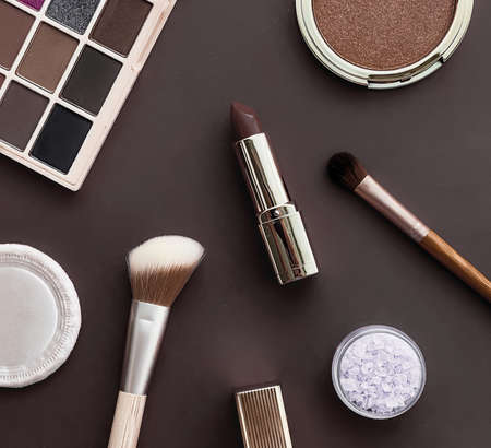 Beauty, make-up and cosmetics flatlay design with copyspace, cosmetic products and makeup tools on brown background, girly and feminine style conceptの写真素材