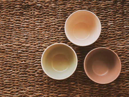 Small empty ceramic measure bowls on rustic wicker background, food preparation flatlay and cooking design conceptの写真素材
