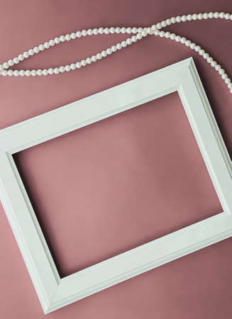 Horizontal art frame and pearl jewellery on blush pink background as flatlay design, artwork print...