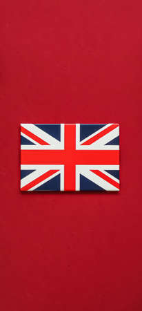 Union Jack flag of Great Britain  on red background, Queen's Platinum Jubilee and holiday celebration conceptの写真素材