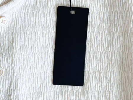 Luxury black fashion label tag, sale price card on fabric background, shopping and retail concept