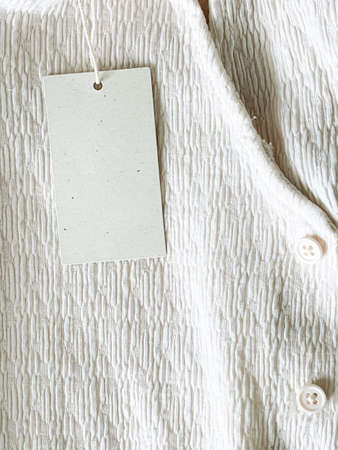 Blank fashion brand label tag, sale price card on luxury fabric background, shopping and retail...