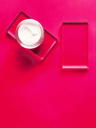 Face cream moisturiser jar on glass and pink background, beauty product and skincare, cosmetic science conceptの写真素材