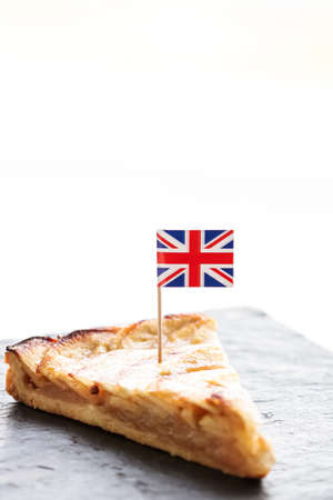 Slice of apple pie and british flag, tart dessert and sweet food conceptの写真素材