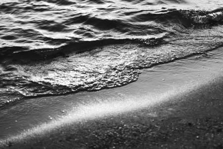 Sea waves and sand in sunshine glow at sunset, black and white art print, sandy beach and coastal...