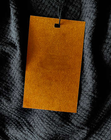 Blank fashion label tag, sale price card on luxury fabric background, shopping and retailの写真素材