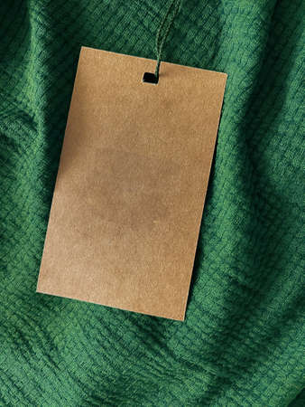 Blank fashion label tag, sale price card on luxury fabric background, shopping and retailの写真素材