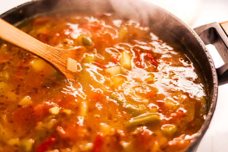 Cooking vegetable soup in saucepan, comfort food and homemade meal concept