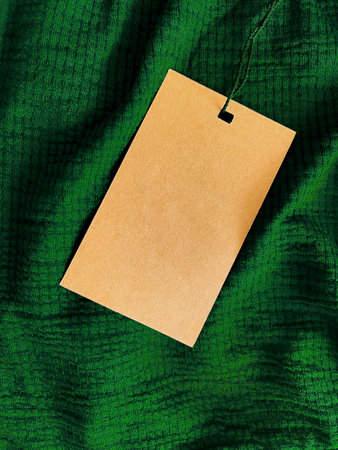 Blank fashion label tag, sale price card on luxury fabric background, shopping and retail conceptの写真素材