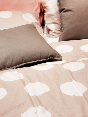 Modern style bedding on bed in bedroom, interior design detail