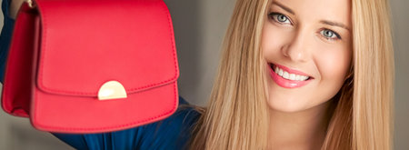 Fashion and accessories, happy beautiful woman holding small red handbag with golden details as stylish accessory and luxury shopping conceptの写真素材
