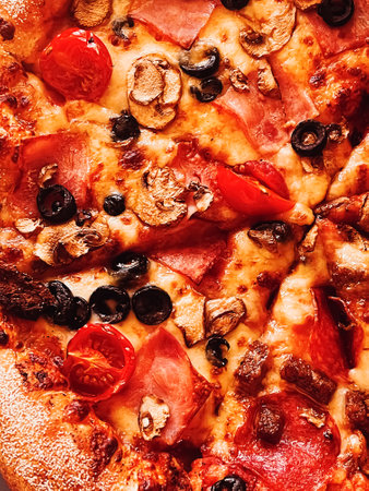 Pizza capriciosa in pizzeria, food background close-up