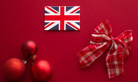 Christmas holiday tradition in United Kingdom and happy holidays flat lay, british flag, xmas ornaments and decoration on festive red background as flatlay design, top viewの写真素材