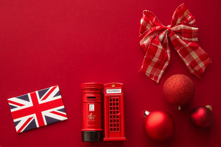 Christmas holiday tradition in United Kingdom and happy holidays flat lay, british flag, London telephone box and xmas decoration on festive red background as flatlay design, top viewの写真素材