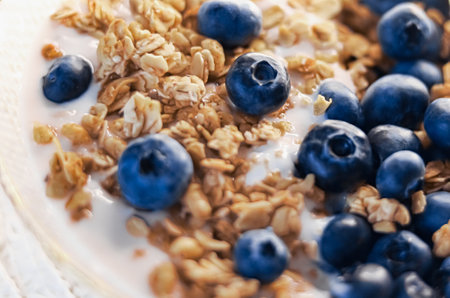 Breakfast idea and delicious food, breakfast cereal grains with lactose-free yoghurt and fresh organic blueberries in a bowl, tasty and healthy recipe, food photographyの写真素材