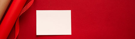 Christmas ornaments, gifts and decoration with white empty blank greeting or business card or thank you note on festive red background as happy holidays flatlay.の写真素材