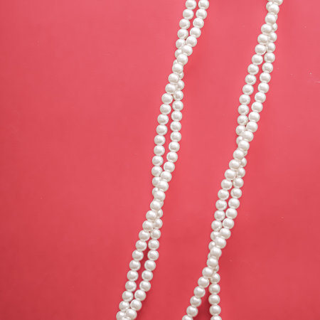 Pearl jewellery necklace on coral background.の写真素材