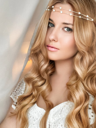 Beautiful bridal look, bride with long hair, wearing pearl tiara jewellery and beauty makeup, blonde woman with curly hairstyle, face portrait for wedding and fashion style ideaの写真素材