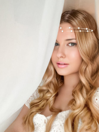 Beautiful bridal look, bride with long hair, wearing pearl tiara jewellery and beauty makeup, blonde woman with curly hairstyle, face portrait for wedding and fashion style ideaの写真素材