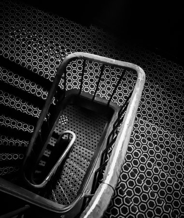 Black and white spiral staircase showcasing a repeating hexagon pattern on the steps and floor, creating a strong graphic design. Paris, Franceの写真素材