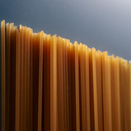 Whole wheat spaghetti pasta standing vertically, forming an abstract gradient of lines and textures...