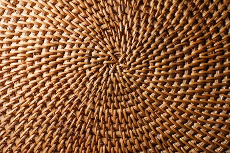 Rattan weaving close up forming an intricate, circular pattern. Demonstrating organic texture and traditional handicraftの写真素材