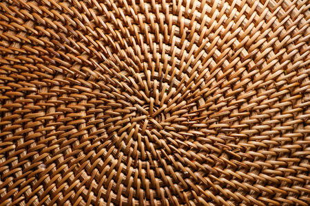 Wicker rattan weaving creating a textured background. Close up view of handmade craft and natural material patternの写真素材
