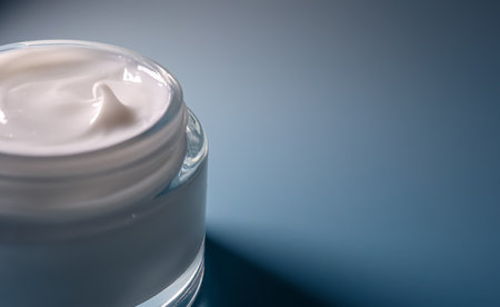 White skincare moisturizing cream in glass jar, hydrating cosmetic product for beauty and anti aging treatments on blue backgroundの写真素材