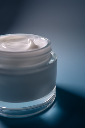 Cream jar closeup showing white cosmetic texture. Perfect for concepts of beauty, skincare,...