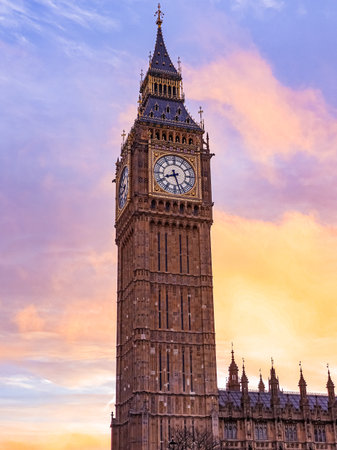 Elizabeth Tower in London standing tall against a colourful sunset sky, representing UK history and travel to Westminsterの写真素材