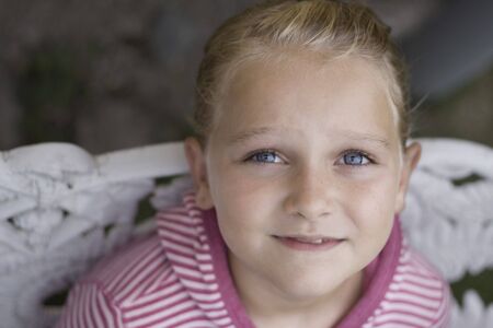 Soft focus horizontal of a girl aged 8, looking away from the cameraの写真素材