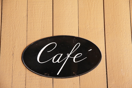 An old coffee shop sign on wooden wall  Space for textの写真素材