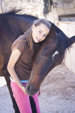 A teenage girl with her horse. の写真素材