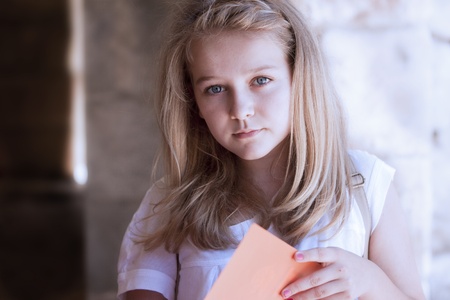 A high school girl preparing for an exam or doing her homework, looking at the cameraの写真素材