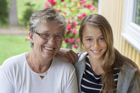 Grandmother and grandchild looking at camera