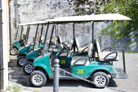 Green golf carts parked outside a country club in Italyのeditorial素材