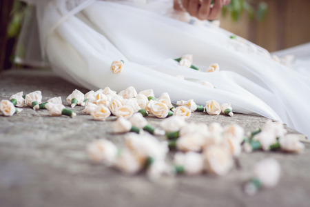 close up of flower buds next to a bride or girl dressed for first holy communion. Soft blurの写真素材