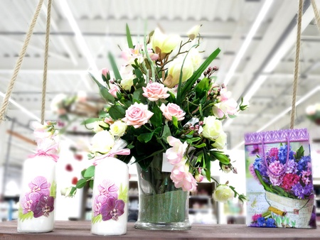 Flower bouquet with roses and orchids, candles and a giftの素材