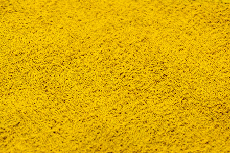 The texture of the towel. Close-up. Bright yellow rectangular background.の写真素材