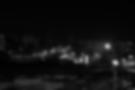 Blurred dark background with light spots. Rectangular photo.の写真素材