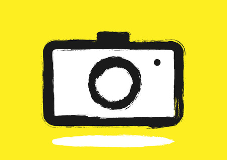Logo camera painted by hand with a rough brush. Grunge, sketch, graffiti, ink. Black, white, yellow. Vector illustration.のイラスト素材