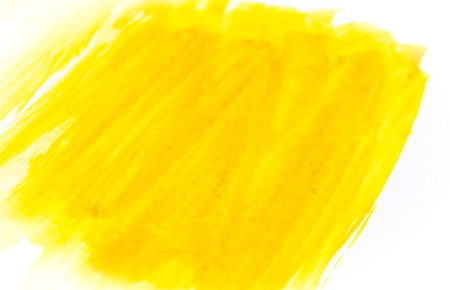 Texture of yellow watercolour paint on white paper. Horizontal watercolor background. Rectangular photo.の写真素材