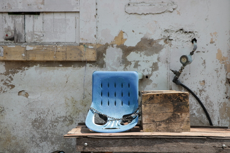 Vintage Wall Background with Old Blue Chairの写真素材