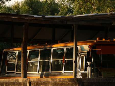 Thai Vintage School Bus in Old Parking Lotの写真素材